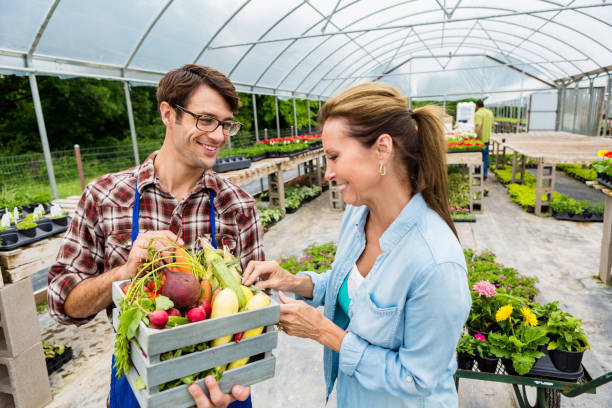 istock Local farmer talks with customer at farmers' market 542204592