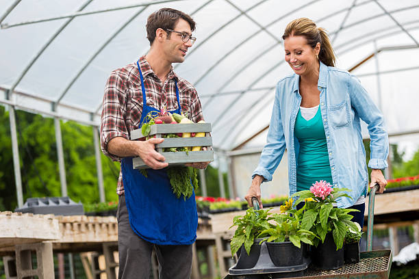 istock Garden center employee assists female customer 542204632