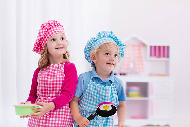 istock Cute kids playing with toy kitchen 542205398