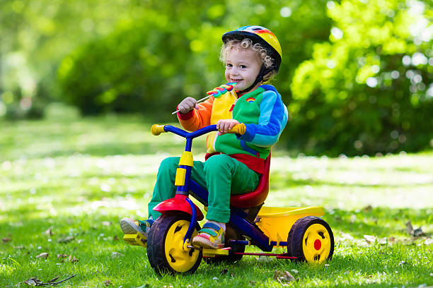 istock Cute little boy on colorful tricycle 542206930