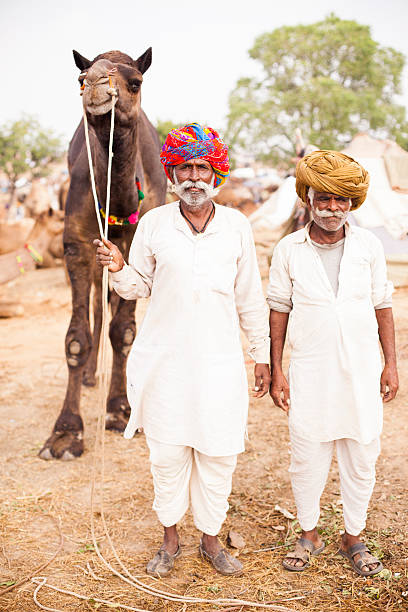 istock Senior Indian Men Selling Camel 542207404