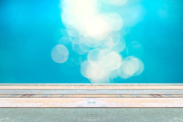 istock Wood table top and blurry blue water bokeh abstract background 542207956