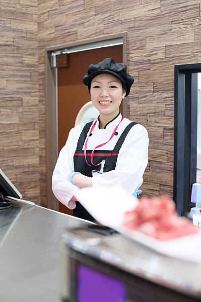 istock Female butcher in a supermarket 542208020
