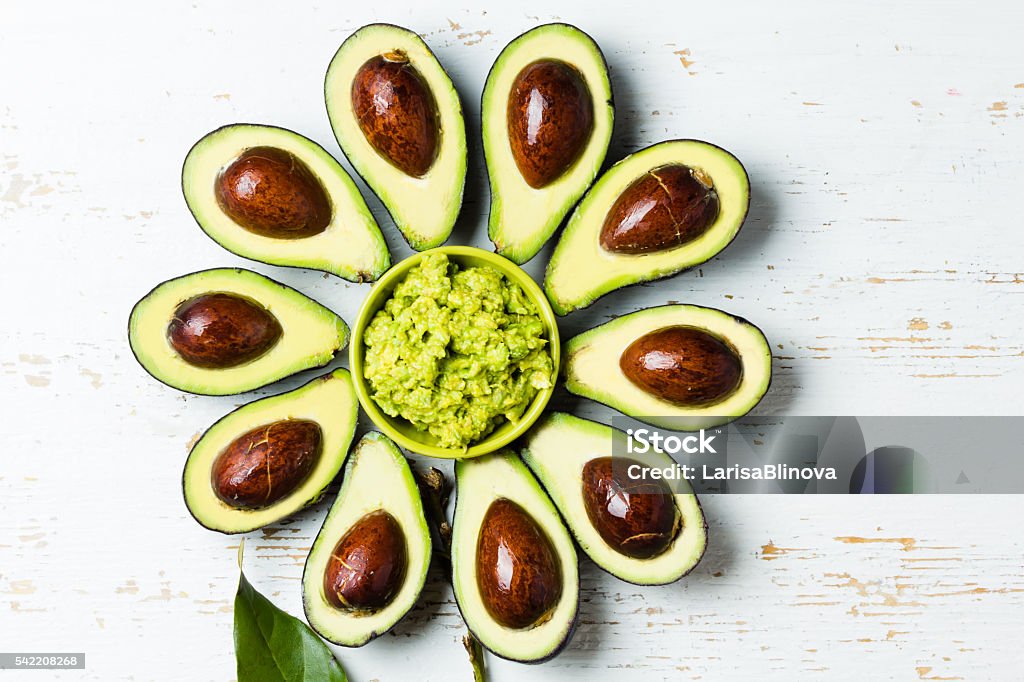 Flower made from avocado and guacamole bowl Avocado. Flower made from avocado and guacamole bowl on white background. Top view Appetizer Stock Photo