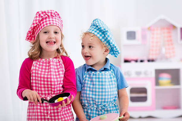 istock Happy kids playing with toy kitchen 542210860