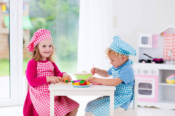 istock Little kids playing with toy kitchen 542211250