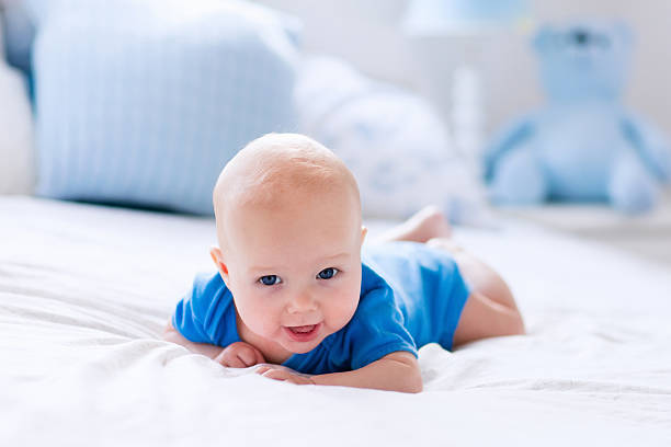 istock Baby boy in white sunny bedroom 542212726