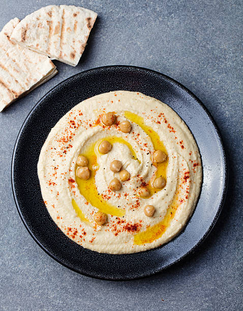 istock Hummus, chickpea dip, spices and pita, flat bread Top view 542213276