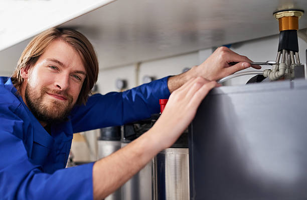Say hello to hot water Portrait of a skilled handyman repairing a water heater bathroom geyser stock pictures, royalty-free photos & images