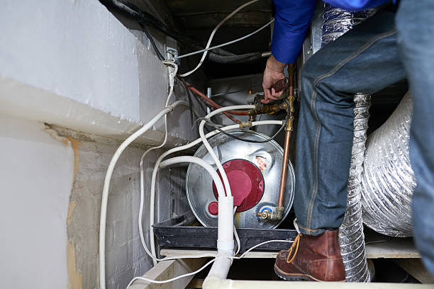 Tracing the faulty pipe to it's source Cropped shot of a handyman repairing a pipe on a water heater bathroom geyser stock pictures, royalty-free photos & images