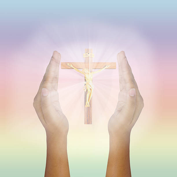 istock Prayer raised hands for glowing Jesus Christ on the Cross 542215704