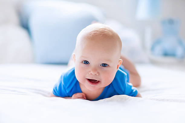 istock Beautiful baby boy in white sunny bedroom 542215826