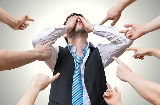 istock Many hands pointing at disappointed man and blame him. 542218284