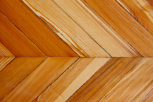Varnished natural wooden floor detail row pieces. Parquet. Horizontal