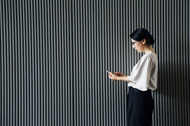 istock Japanese woman is watching her mobile phone 542285490