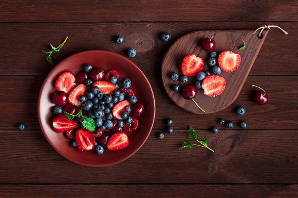 istock fruit salad on wooden background, top view, flat lay 542285902