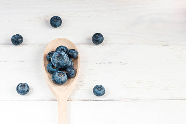 istock blueberries on wooden spoon, top view, flat lay 542286096