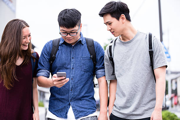 istock Reading Jokes on Smartphone while walking to the college 542286156