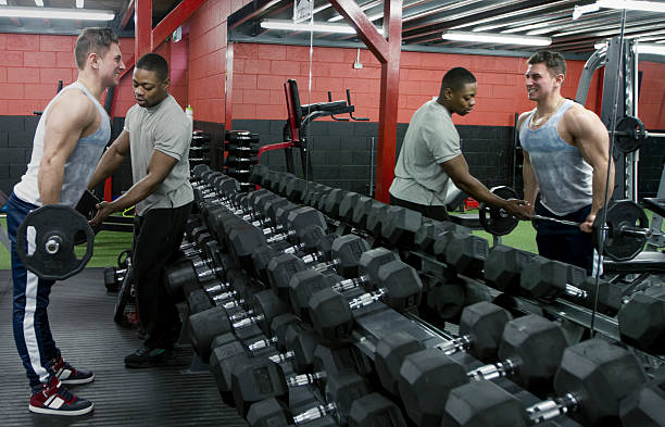 Personal trainer helping and motivating exercise in the gym