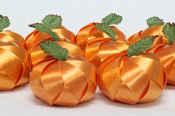 ribbon wrapped coins orange fruit