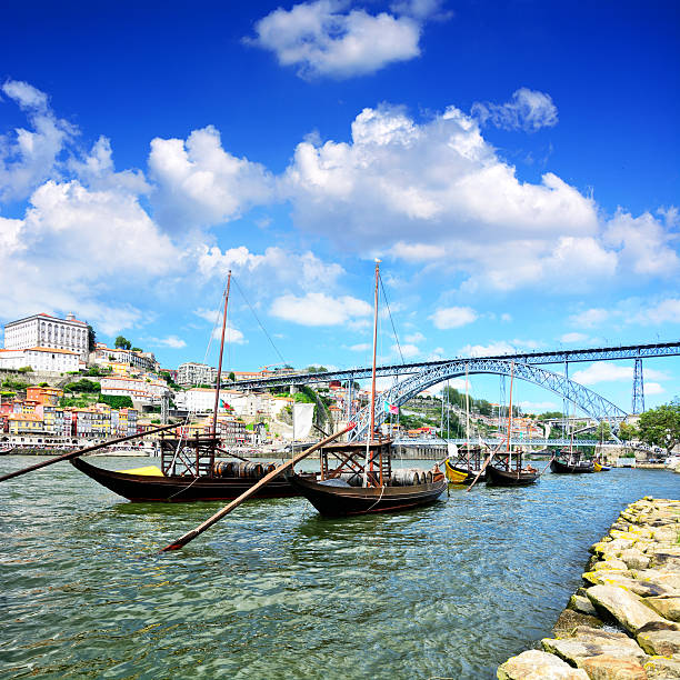 Port Skyline Rabelo boats on the Douro river and Dom Luis I bridge in Porto, Portugal. Composite photo rabelo boat stock pictures, royalty-free photos & images