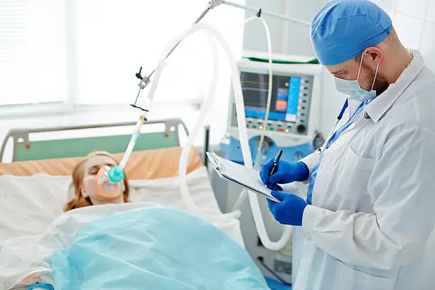 Doctor filling in record of patient before operation