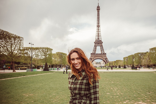 Young girl against the Eiffel tower looking at camera.Istockalypse Paris 2016