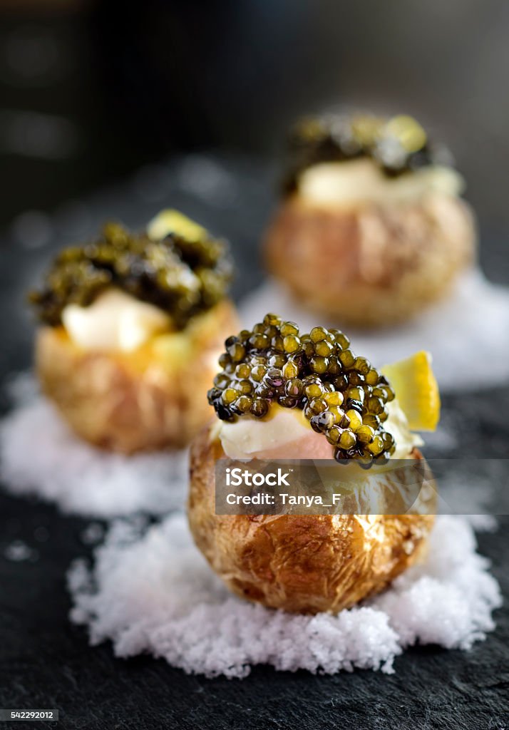 Baked Potatoes with Black Caviar Baked Potatoes with Black Caviar and Sour Cream Caviar Stock Photo