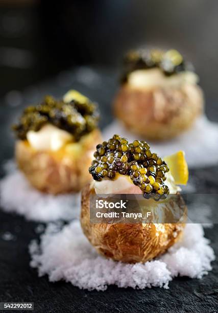 Baked Potatoes With Black Caviar Stock Photo - Download Image Now - Caviar, Gourmet, Appetizer