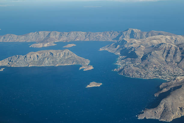 elevated view of greek telendos and part of kalymnos island - mountain range earth sky airplane imagens e fotografias de stock