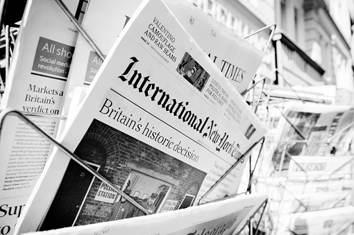 Strasbourg, France - June 24, 2016: International New York Times and other major newspapers headline titles at press kiosk about the Brexit referendum in United Kingdom which has decidedthe country wishes to quit the European Union