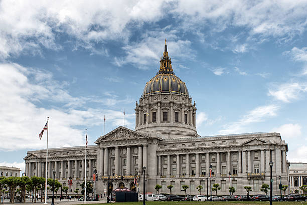 The gold-accented dome of San Francisco City Hall set against a blue sky.