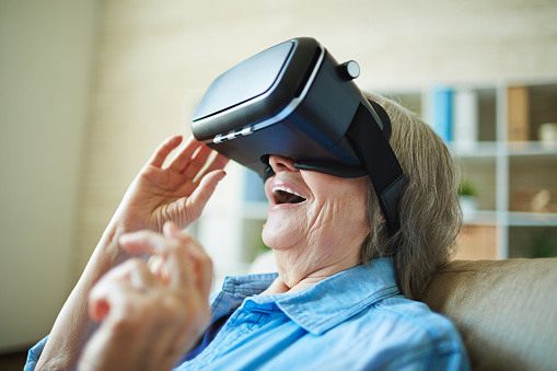 Astonished senior woman with vr glasses