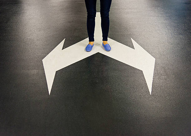 istock Feet and two arrows painted on floor 542298142