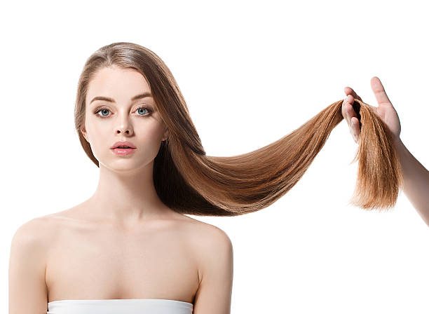Beautiful woman with healthy long hair keep it in hand