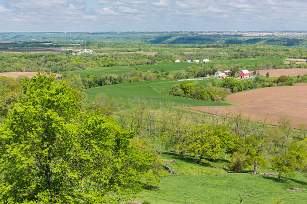 Rural Midwestern landscape with woods, fields, roads and houses in the fall