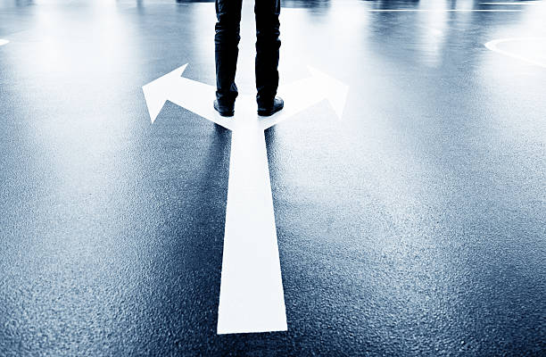 istock Feet and two arrows painted on floor 542299684