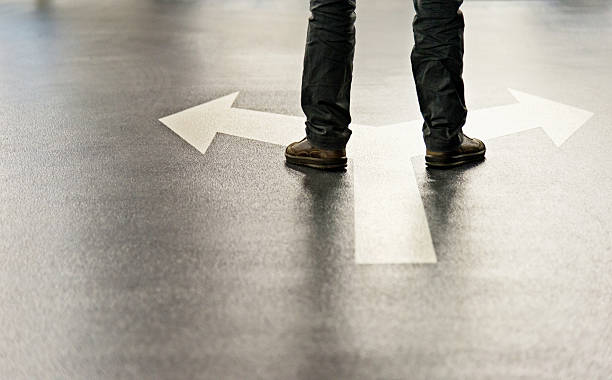 istock Feet and two arrows painted on floor 542300262