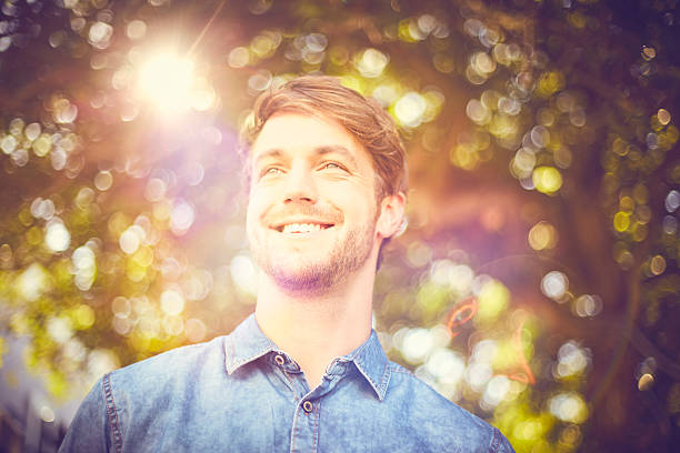 istock Young trendy man smiling while looking away outdoors 542301268