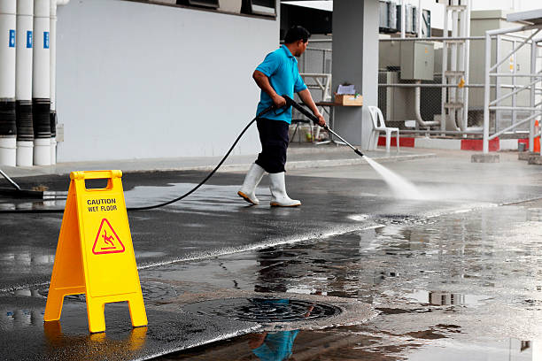 istock caution wet floor banner and worker cleaning floor 542302026