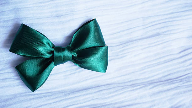 istock green ribbon bow on white fabric  background 542302280