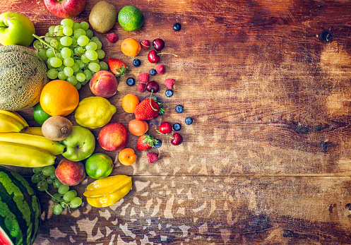 Huge Group of Fresh Fruits on Wooden Background