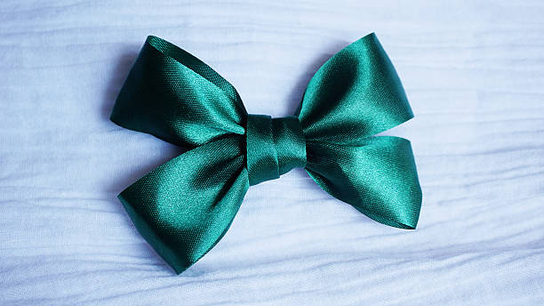 istock green ribbon bow on white fabric  background 542304308