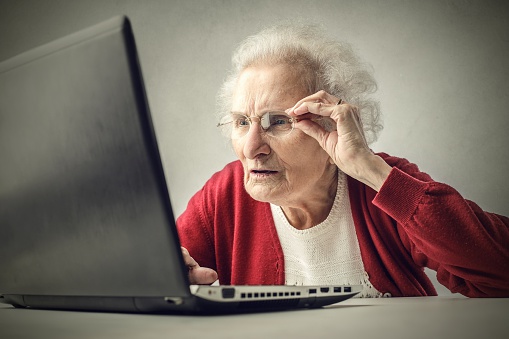 Little old lady trying to understand laptop 