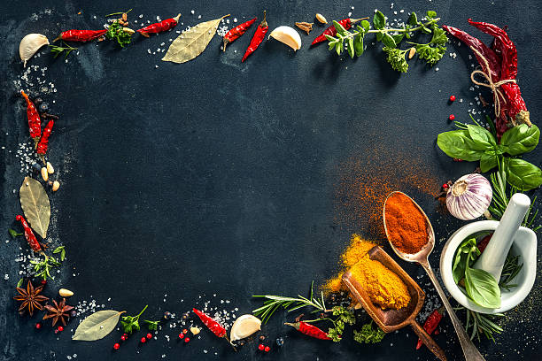 istock Herbs and spices over black stone background 542306808