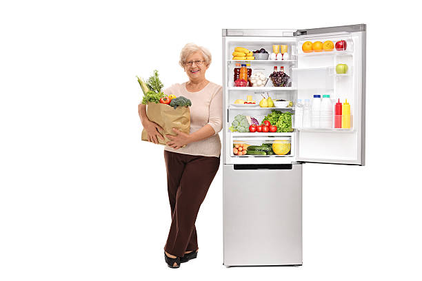 istock Senior lady leaning on a fridge 542306938