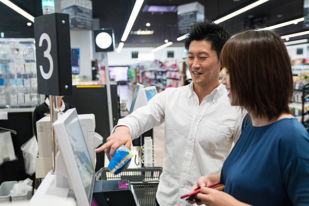istock Couple using a digital cash register and check-out system 542307134