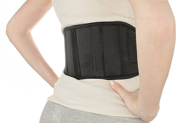 istock woman wearing back support belt isolated on white 542307160