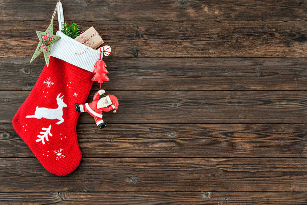 Christmas decoration stocking Christmas decoration stocking and toys hanging over rustic wooden background christmas stocking stock pictures, royalty-free photos & images