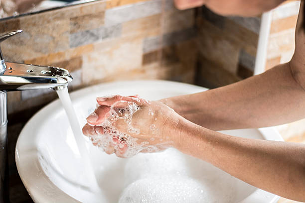 lavando as mãos com sabão  - one person sink washing hands bathroom - fotografias e filmes do acervo